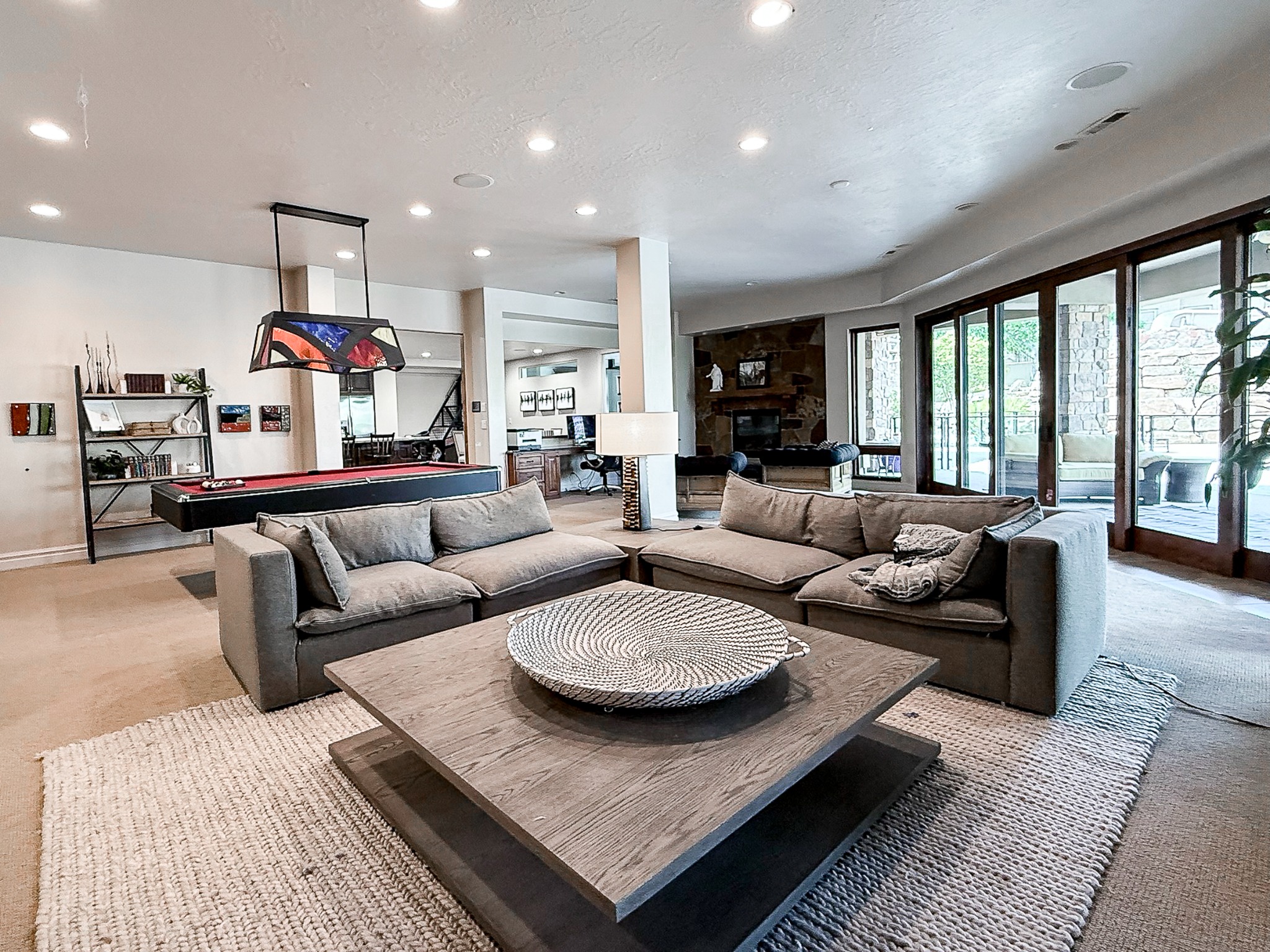 Lower-level family room with seating and billiards
