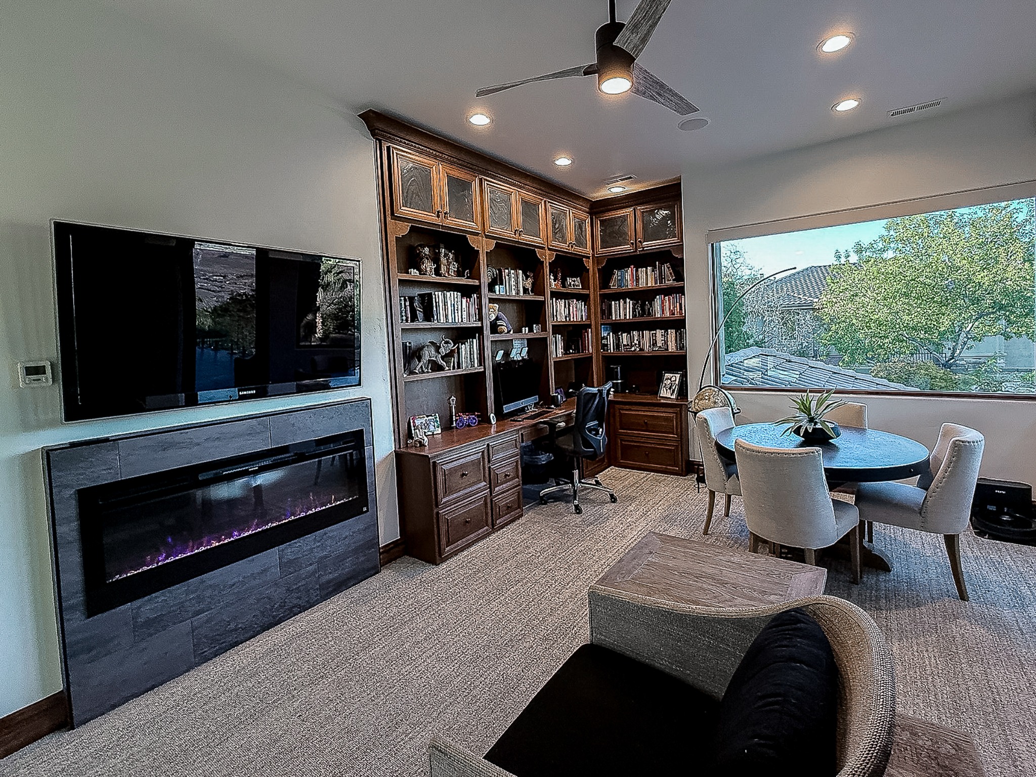 Office with built-in cabinetry, fireplace, sitting area, and Murphy bed